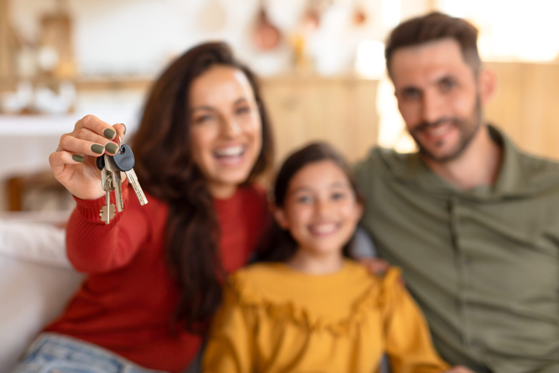 Family holding keys to their new home after finding out how much how can i afford