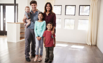 Portrait of happy family with baby who got a loan with FMS's USDA Home Loans